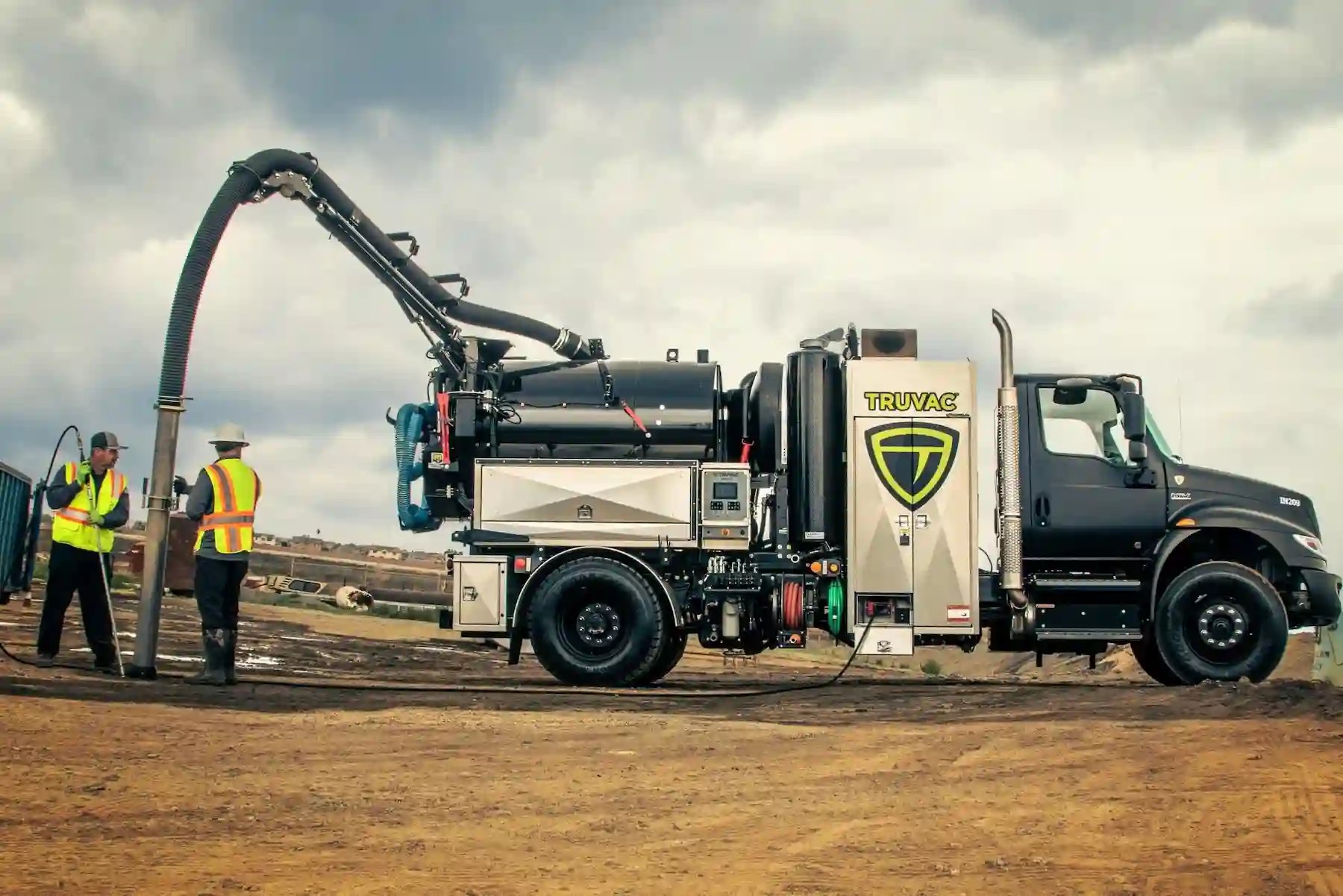 TRUVAC Paradigm hydro excavation truck with crew members outdoors, highlighting field operations, team collaboration, and non-destructive excavation capabilities.